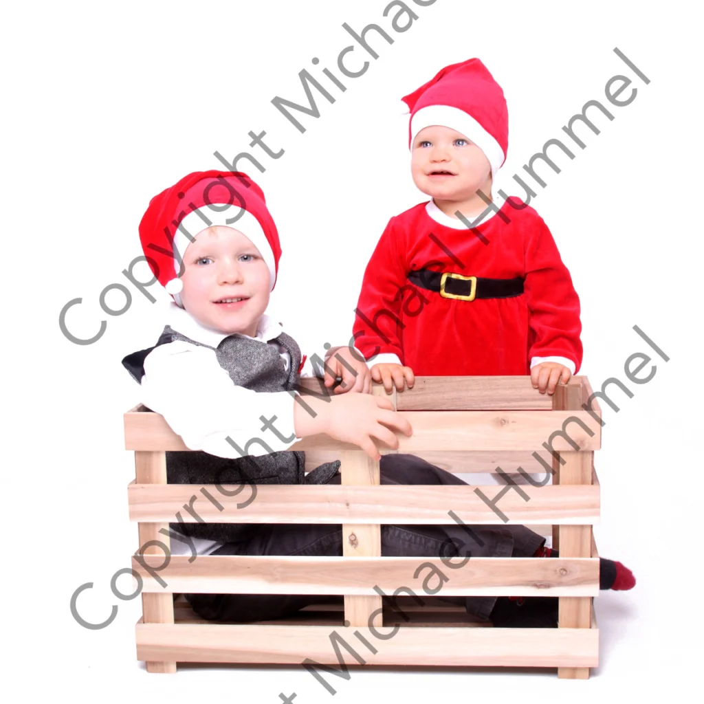 Zwei Kleinkinder im Weihnachtskostüm